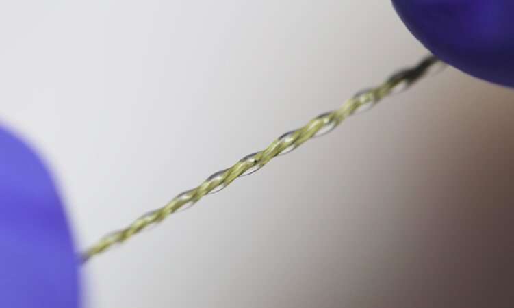 A stretchable and suturable fiber sensor to monitor biomechanical tissue strain